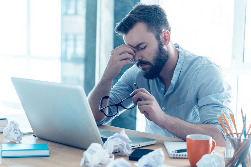 upset and frustrated man at his computer