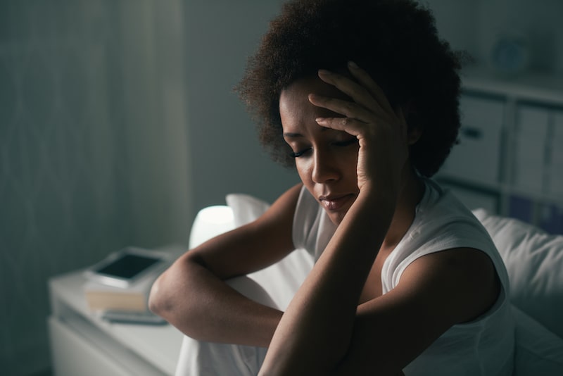 sad woman sitting in darkness