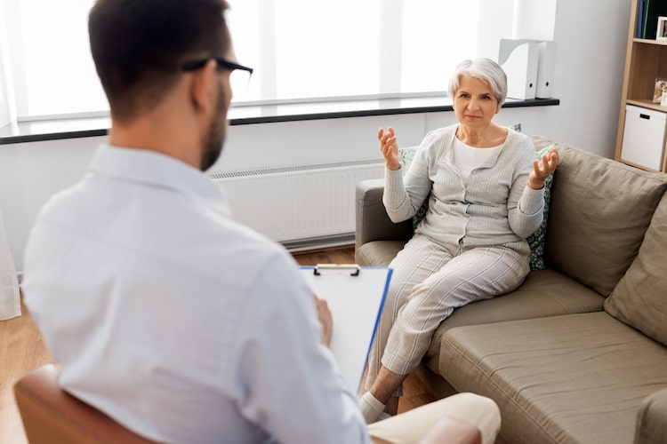older woman talking to a male therapist