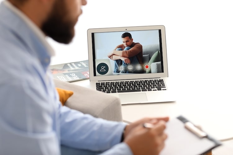 person looking at a computer where a teenager is upset