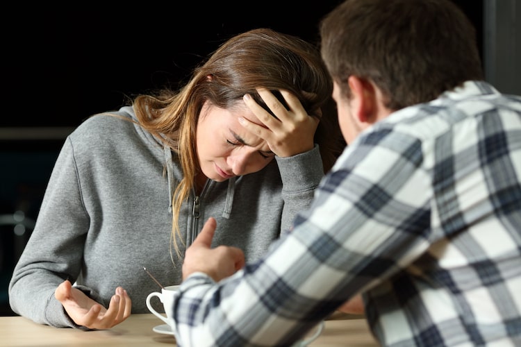 upset women being yelled at by a man